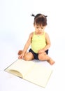 Portrait of little cute baby girl reading book. Royalty Free Stock Photo