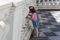 Little girl walks in the park and looks through the biton fence Royalty Free Stock Photo