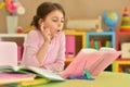 Portrait of little cute girl doing homework Royalty Free Stock Photo