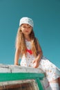 Portrait of little cute girl enjoying playing on boat on a hot s Royalty Free Stock Photo