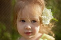 Portrait of a little cute girl with a jasmine flower in her hair Royalty Free Stock Photo