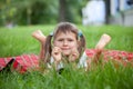 Portrait of little cute girl lies green grass Royalty Free Stock Photo