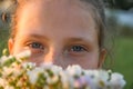 Portrait of little cute girl looking into the frame smiling. Outdoors on a background of green grass and forest Royalty Free Stock Photo