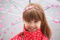 Portrait of little cute girl in red rain coat under the umbrella Royalty Free Stock Photo
