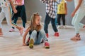 Portrait of a little cute girl sitting on the floor and looking away while having a choreography class in the dance Royalty Free Stock Photo