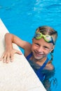 Portrait of little cute girl in the swimming pool.