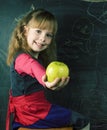 Portrait of little cute girl writing on the blackboard in classroom, lifestyle education people concept Royalty Free Stock Photo