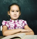 Portrait of little cute girl writing on the blackboard in classroom, lifestyle education people concept Royalty Free Stock Photo