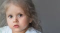 Portrait of a little cute three year old girl with big sad eyes Royalty Free Stock Photo