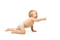 Portrait of little cute toddler boy, baby in diaper crawling isolated over white studio background Royalty Free Stock Photo