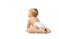 Portrait of little cute toddler boy, baby in diaper crawling isolated over white studio background. Side view Royalty Free Stock Photo