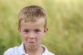 Portrait of a little displeased and dissatisfied boy with golden Royalty Free Stock Photo