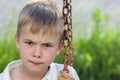 Portrait of a little displeased and dissatisfied boy with golden Royalty Free Stock Photo