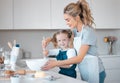 Portrait of a little girl baking with her mother. Happy mother helping her daughter bake. Parent baking with her child Royalty Free Stock Photo