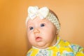 Portrait of a little girl with a bandage on her head on a beige background Royalty Free Stock Photo