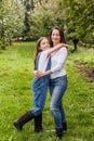 Portrait of little girl and beautiful mother in organic apple orchard happy and having fun Royalty Free Stock Photo