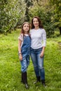 Portrait of little girl and beautiful mother in organic apple orchard happy and having fun Royalty Free Stock Photo