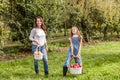 Portrait of little girl and beautiful mother in organic apple orchard happy and having fun Royalty Free Stock Photo