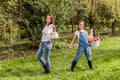 Portrait of little girl and beautiful mother in organic apple orchard happy and having fun Royalty Free Stock Photo