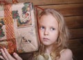 Portrait of a little girl and a big gift box.