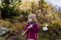 Portrait of little girl with bindle during autumn hike in mountains.