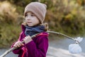 Portrait of little girl with bindle during autumn hike in mountains.