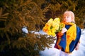 Portrait of Little girl in blue coat, yellow scarf and bouquet of flowers in winter or spring in nature in the Royalty Free Stock Photo