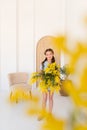 Portrait of a little girl with a bouquet of spring yellow flowers Royalty Free Stock Photo