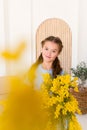 Portrait of a little girl with a bouquet of spring yellow flowers Royalty Free Stock Photo