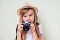Portrait of a little girl with a camera.Image of cute girl in a straw hat tourist photographer Royalty Free Stock Photo