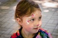 Portrait of a little girl with a cat drawn on her face. Tattooing for a young child. Children`s creativity. Beautiful figure on Royalty Free Stock Photo