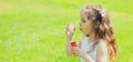 Portrait little girl child blowing soap bubbles in summer day Royalty Free Stock Photo