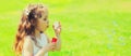 Portrait of little girl child blowing soap bubbles in summer day Royalty Free Stock Photo