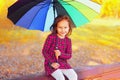 Portrait of little girl child with colorful umbrella in sunny autumn park Royalty Free Stock Photo