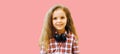 Portrait of little girl child with headphones listening to music on pink background Royalty Free Stock Photo