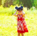 Portrait of little girl child looking through binoculars outdoors in sunny summer day Royalty Free Stock Photo