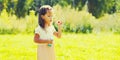 Portrait of little girl child playing blowing soap bubbles in sunny summer day Royalty Free Stock Photo