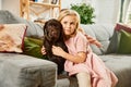 Portrait of little girl, child playing, hugging purebred dog, brown labrador at home. Having fun Royalty Free Stock Photo