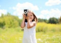 Portrait of little girl child with retro vintage camera outdoors Royalty Free Stock Photo