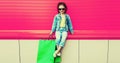 Portrait of little girl child with shopping bags wearing denim clothes on the city street Royalty Free Stock Photo