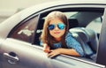 Portrait of little girl child sitting in car as passenger looking out of car window Royalty Free Stock Photo