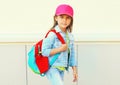 Portrait of little girl child wearing a baseball cap with backpack Royalty Free Stock Photo