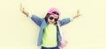 Portrait of little girl child wearing baseball cap with pink backpack on city street background Royalty Free Stock Photo