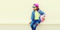 Portrait of little girl child wearing baseball cap with pink backpack on city street background Royalty Free Stock Photo