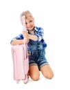 Portrait of a little girl collects suitcase vacation rental