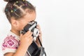 Portrait of a little girl in a colorful dress taking pictures on an old vintage camera Royalty Free Stock Photo