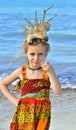 Portrait of a little girl with a coral crown on her head Royalty Free Stock Photo