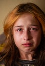 Portrait of little girl crying with tears rolling down her cheeks. Girl crying. Girl 9 years old is very upset. Teenage Royalty Free Stock Photo