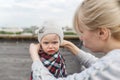 Portrait of the little girl with the dirty person. Mother cares for the daughter. Roof.