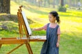 Portrait of little girl do painting in garden or park with morning light Royalty Free Stock Photo